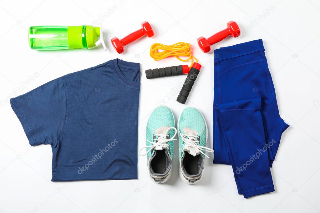 Healthy lifestyle accessories on white background, top view