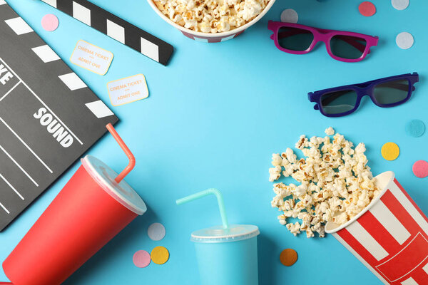 Flat lay composition with drinks, popcorn, 3d glasses, clapperbo