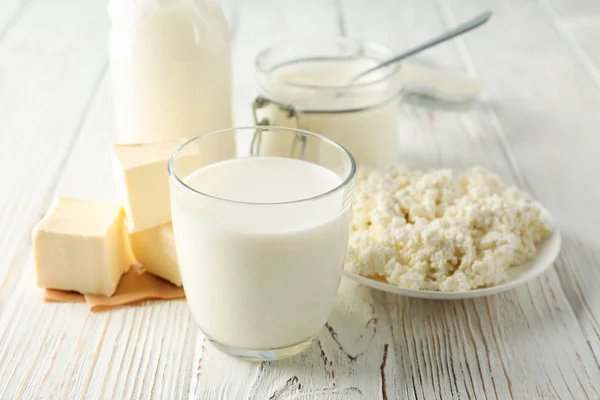 Different dairy products on white wooden background, space for t — Stock Photo, Image