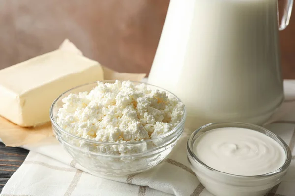 Milk, cottage cheese and butter against brown background, closeu — Stock Photo, Image