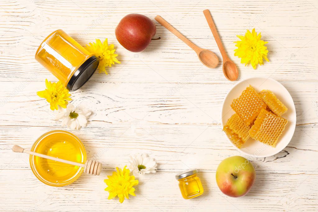 Honey, flowers and apples on white wooden background, copy space