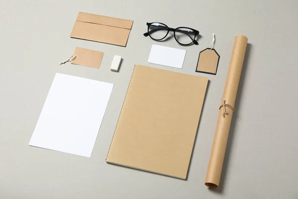 Mockup. Corporate stationery and glasses on grey background, cop