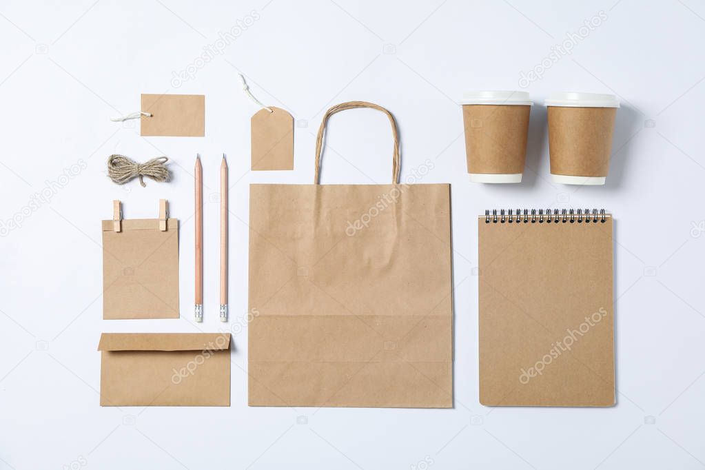 Flat lay composition with blank stationery, paper cups and bag o