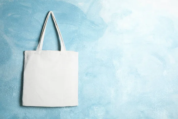 Tote cotton bag on color wall, space for text