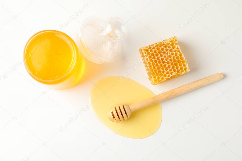 Jar with honey, dipper and honeycomb on white background, copy s