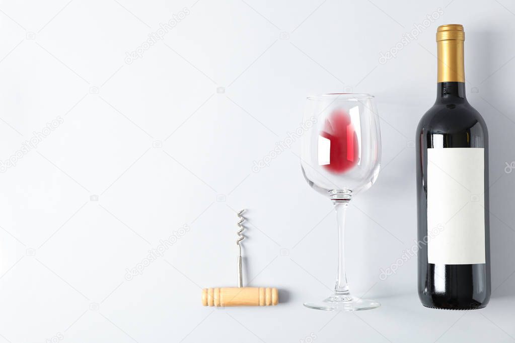 Flat lay composition with corkscrew, bottle and glass with wine,