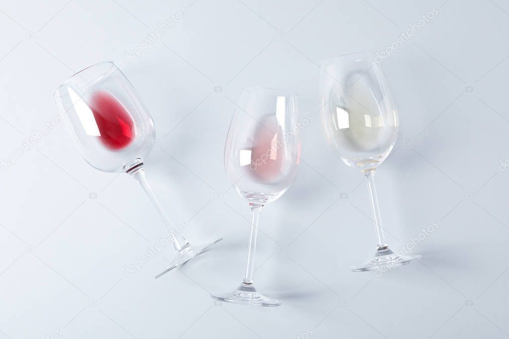 Flat lay. Glasses with different wine on grey background, copy s