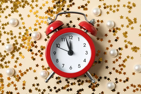 นาฬิกาปลุกและแวววาวบนพื้นหลังสีฟ้า สุขสันต์วันปีใหม่ — ภาพถ่ายสต็อก