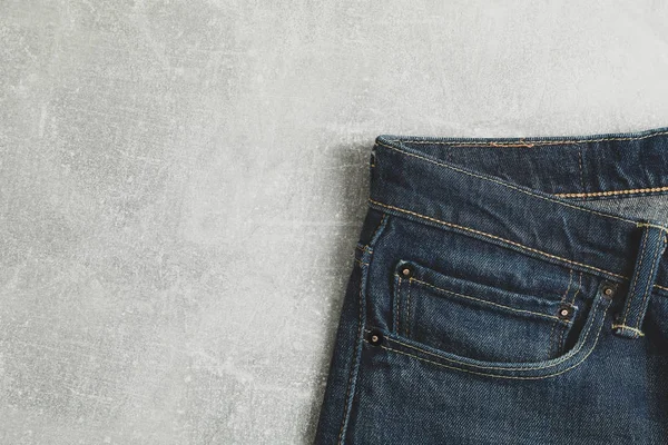Classic jeans on grey background, space for text — Stock Photo, Image