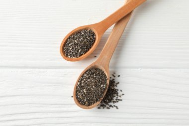 Chia tohumları ve beyaz ahşap arka plan üzerinde tahta kaşık, kopya sp