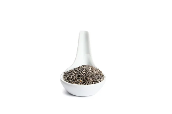 Sementes de chia em colher de porcelana isolada sobre fundo branco — Fotografia de Stock