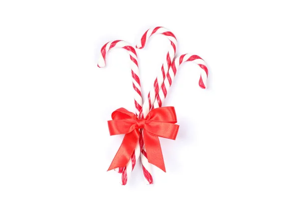 Sweet candy canes with bow isolated on white background — Stock Photo, Image