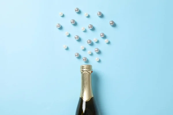 Bouteille de champagne et paillettes sur fond bleu, espace pour le texte — Photo