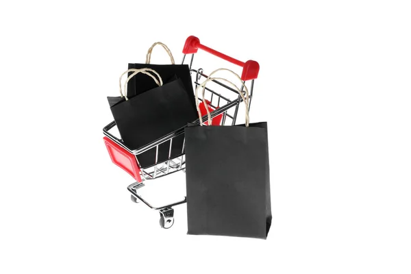 Small shop cart with paper bags isolated on white background