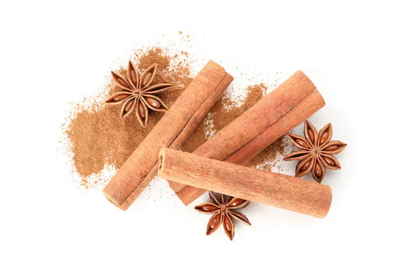 Cinnamon powder, sticks and anise isolated on white background