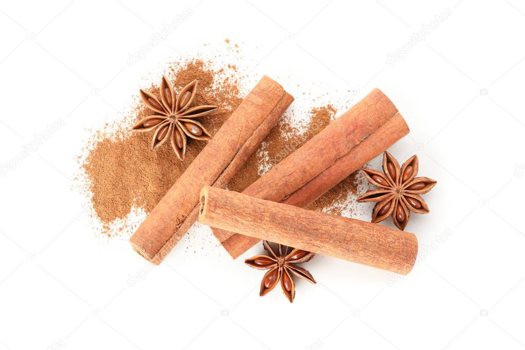 Cinnamon powder, sticks and anise isolated on white background