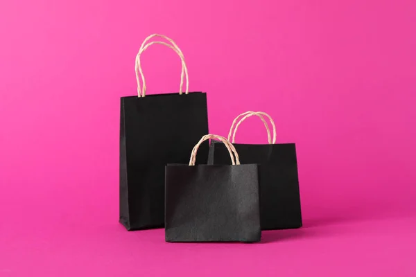 Small paper bags on pink background, space for text — Stock Photo, Image