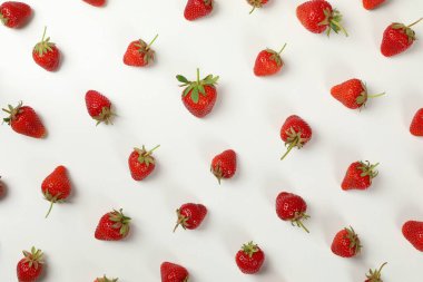 Beyaz arka planda lezzetli çilekli düz bir yer, üst manzara. Yaz meyvesi