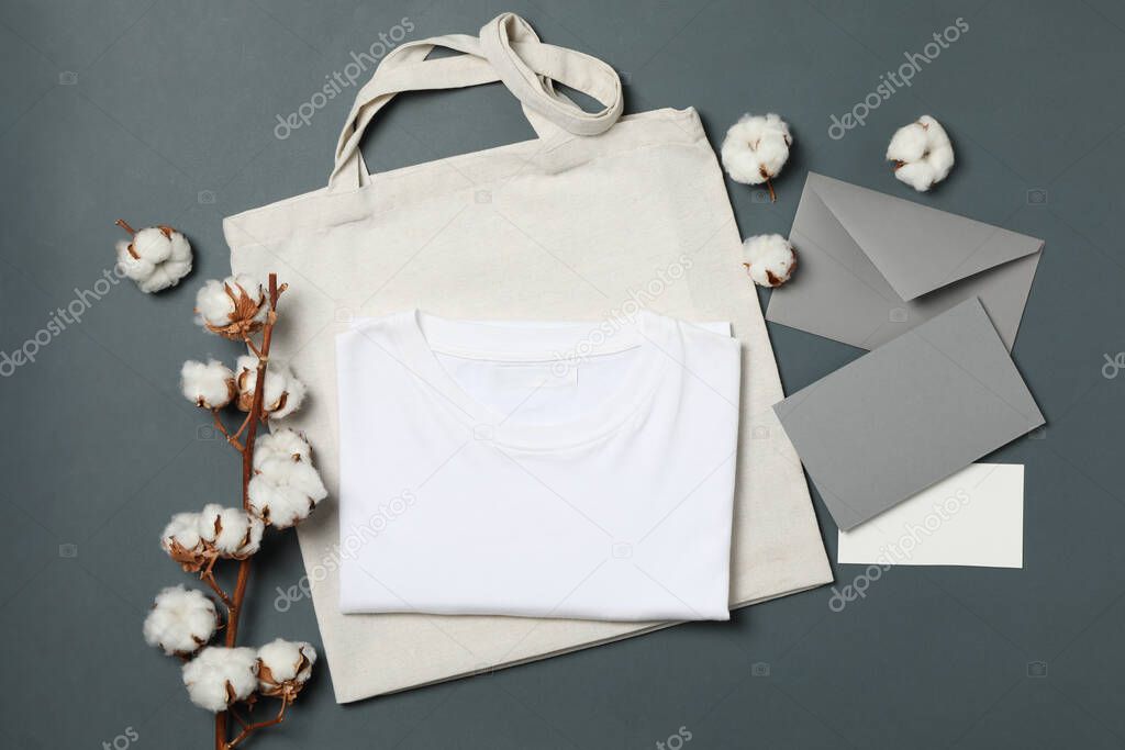 Cotton, bag, t-shirt and envelope on light black background, space for text