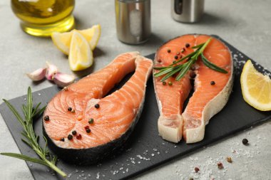 Gri arka planda somon eti ve baharatlı kompozisyon, kapat.