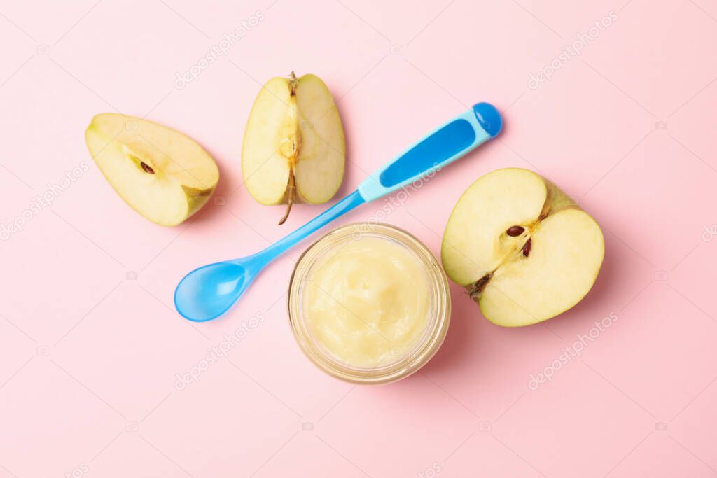 Vegetable puree, apples and spoon on pink background. Baby food