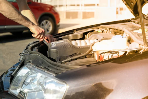 Man fixing engine. Car inspection. Work of mechanic