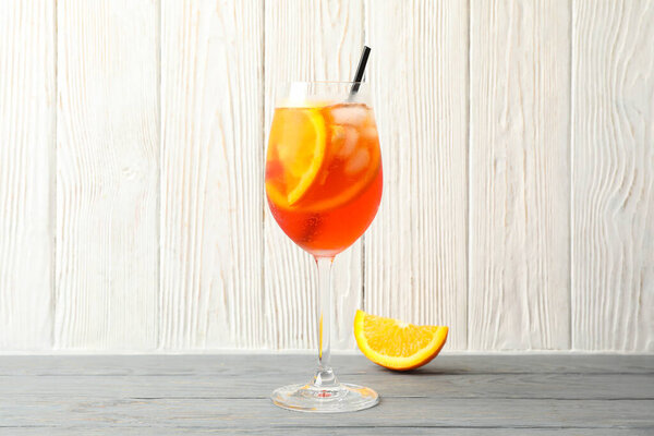 Aperol spritz cocktail on wooden background. Summer drink