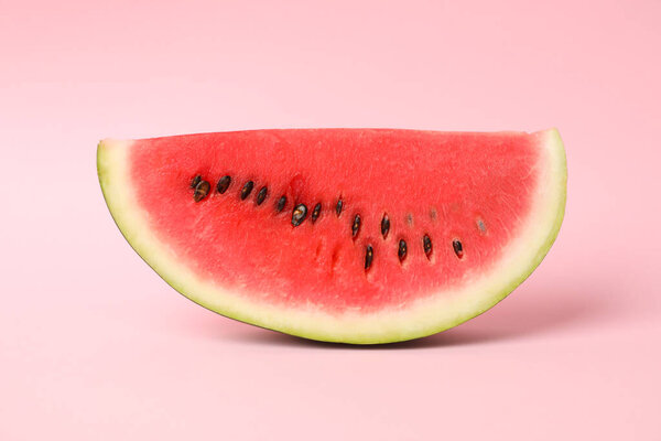 Slice of fresh watermelon on pink background. Summer fruit