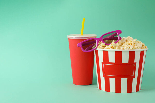 Drink, bucket with popcorn and 3d glasses on mint background