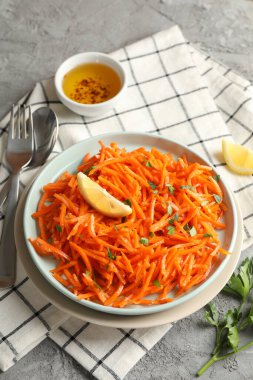 Gri arka planda lezzetli havuç salatası kompozisyonu. Kore havucu