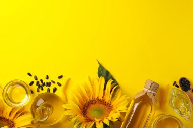 Sarı zemin üzerinde ayçiçeği ve yağ ile kompozisyon, metin için boşluk