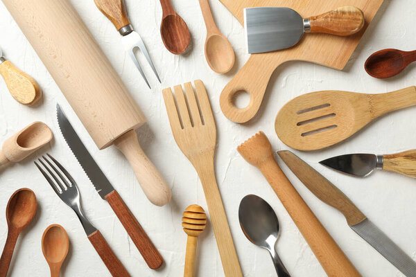Composition with different kitchen cutlery on white background
