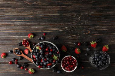 Ahşap arka planda taze böğürtlen kaseleri ile kompozisyon, üst görünüm