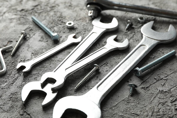 Mechanic tools on gray background, close up