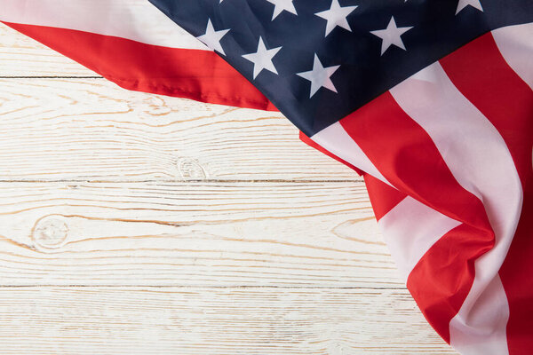 American flag on white wooden background, space for text