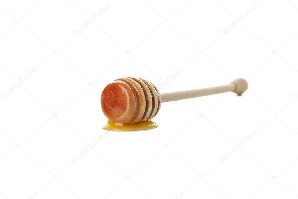 Wooden dipper with honey isolated on white background