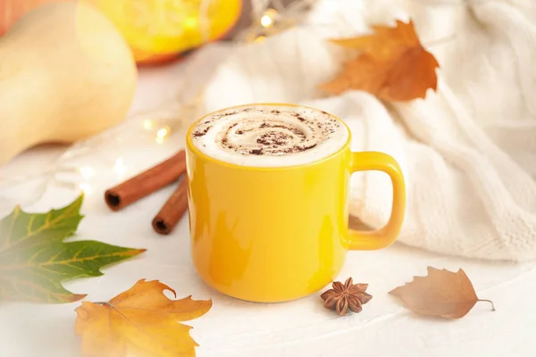 Composition with cup of pumpkin latte on white background