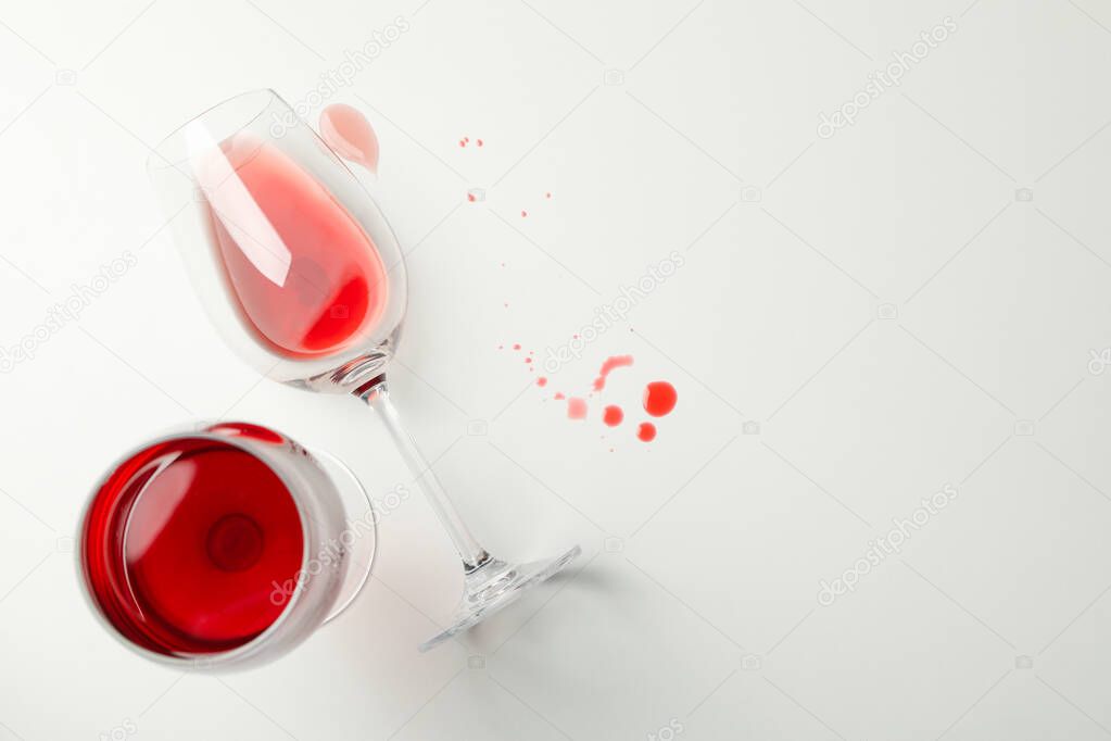 Glasses of wine on white background, top view