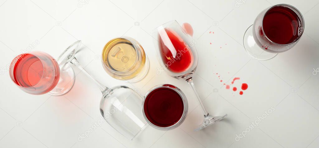 Glasses of wine on white background, top view