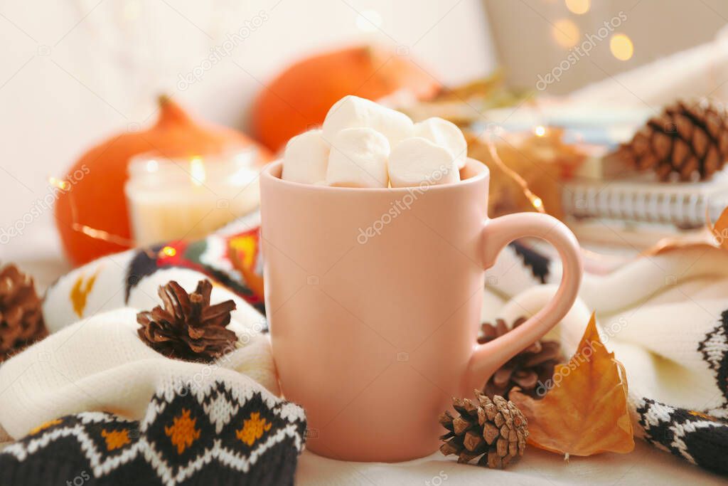 Autumn concept with cup of coffee with marshmallow and sweater