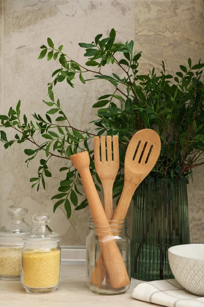 Kitchen table with different supplies and plant