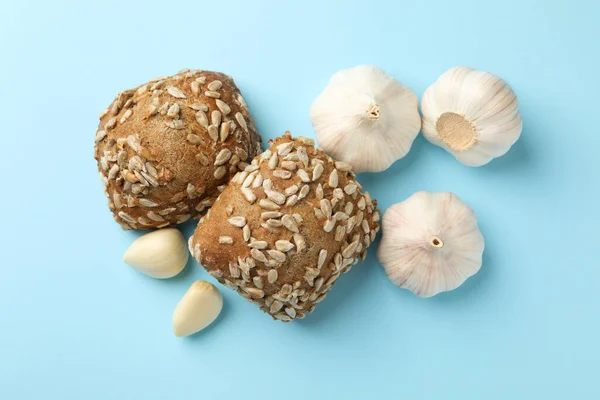 Buns with sunflower seeds and garlic on blue background — Stock Image Buns Sunflower Seeds Garlic Blue Background Stock Image
