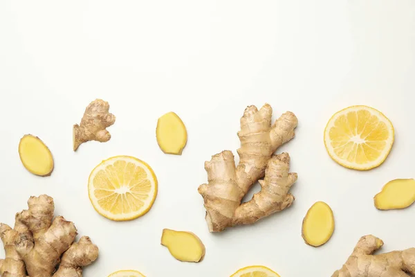 Fresh ginger and lemon on white background, top view