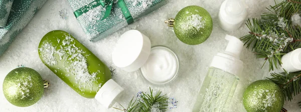 Concept of face care with cosmetics on background with decorative snow