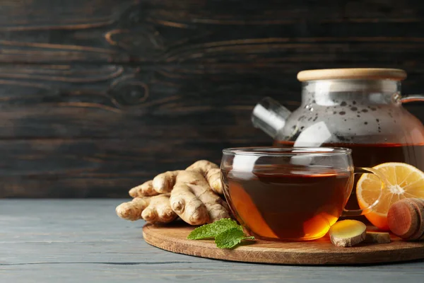 Concept of breakfast with ginger tea on wooden background