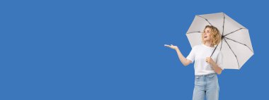 Kadınlar beyaz bir şemsiye tutarken güneşli havayı severler.