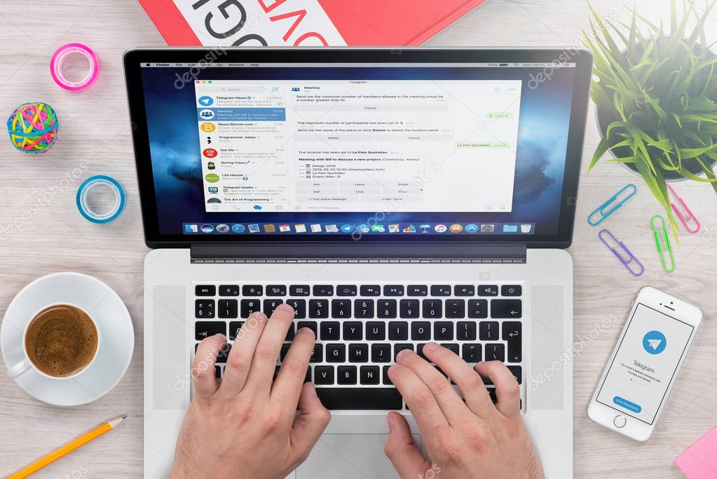 Varna, Bulgaria - January 23, 2018: Top view male hands chatting via desktop Telegram messenger on laptop.