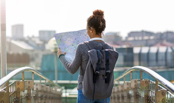 Beautiful girl with map in the city