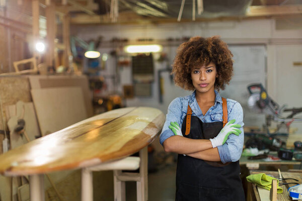 Afro american woman craftswoman working in her workshop