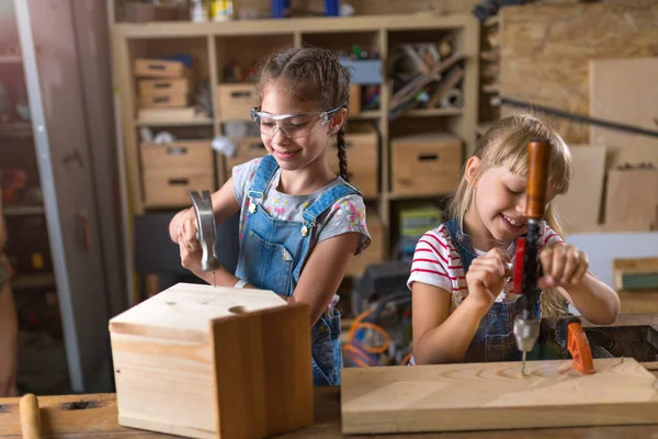 Two Young Girls Doing Woodwork Workshop Royalty Free Stock Images